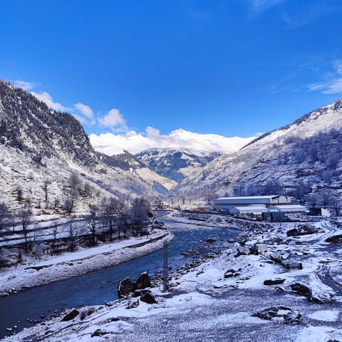 Snow-capped mountains under a deep blue sky